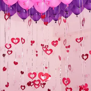 Detailed view of romantic heart balloon string pendants and balloons for wedding decor.