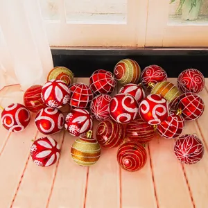Detailed view of 6cm red and gold Christmas balls with glitter painted patterns for tree decor.