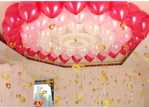 Detailed view of ceiling balloons and golden heart hanging pendants for wedding party decor.