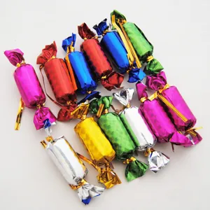 Colorful foil wrapped candy shape decorative items detail shot, vibrant party ornaments.