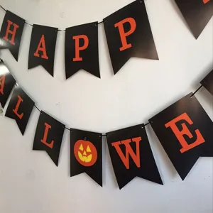 Halloween party decoration banner detail showing black swallowtail flags with orange letters.