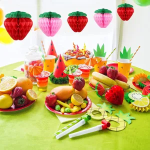 Strawberry honeycomb balls and pineapple paper decorations for birthday party supplies.