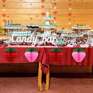 Strawberry honeycomb paper balls for birthday party decor, hanging fruit decorations, detail view.