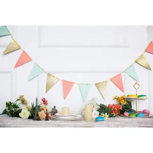 Detail view of glitter triangle bunting banner for party decoration, festive scene setup.