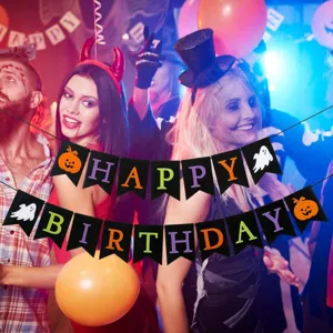 Halloween party banner decoration with Happy Birthday lettering, ghost and pumpkin flags for events.