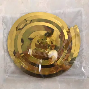 Gold spiral hanging swirls decorations detail view for birthday party wedding backdrop celebration.