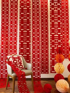 Detail shot of Chinese wedding double happiness hanging strips and honeycomb ball decorations.