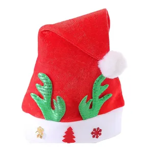 Christmas red hat with green sequin reindeer antlers and white pom-pom for holiday party decor.