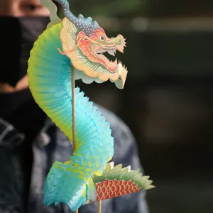 Traditional paper dragon toy with honeycomb folding design, vibrant festive party decoration.