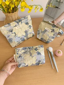 Embossed floral cosmetic bag set, portable travel makeup pouch and toiletry organizer.