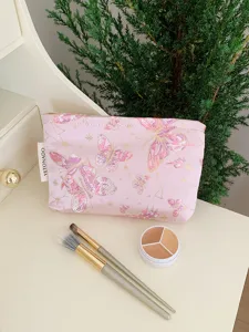 Detail shot of a pink canvas cosmetic pouch featuring delicate gold and butterfly embroidery.