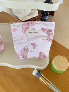 Pink butterfly canvas cosmetic bag, portable travel toiletry pouch for daily skincare storage.