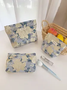 Portable embossed floral cosmetic bag set for travel, elegant jacquard makeup pouch.