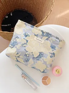 Chic floral jacquard cosmetic bag with secure zipper, perfect portable travel makeup pouch.