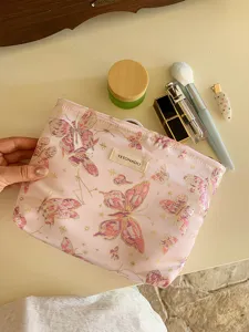 Pink butterfly cosmetic bag, stylish travel makeup pouch and portable toiletry storage.