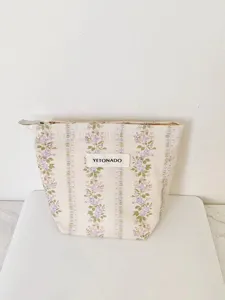 Vintage floral cosmetic bag detail, elegant woven storage pouch with zipper and custom label.