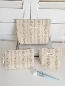 Detail view of vintage floral cosmetic bag set, elegant jacquard stripe fabric for storage.