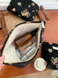 Black vintage tapestry makeup pouch, 3D floral woven cosmetic bag with zipper and large capacity.