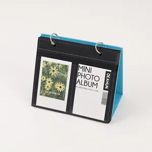 Desktop mini photo album, 3-inch instant film and card holder with metal rings and blue stand.