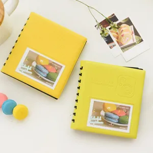 Detail view of yellow 3-inch mini photo album with cute macaron decorations and clear cover.