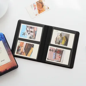Mini 3-inch photo album storage book for polaroid pictures and cards, sleek black design.