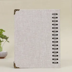 Detailed view of a textured mini photo album with metal corner protectors for 3-inch photos.