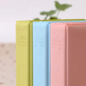 Detailed shot of pastel mini instant photo album, candy color polaroid picture book pocket.