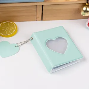 Close-up detail of the mint green heart photocard holder binder with cute pendant.
