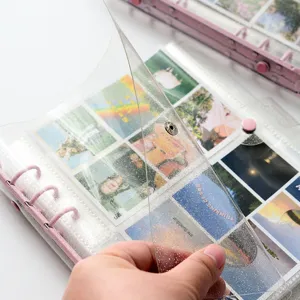 Close-up detail shot of transparent glitter binder photo album page with card inserts.