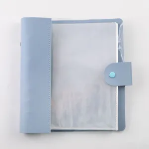 Close-up detail view of the clear inner pages and snap button of the blue photo card binder.