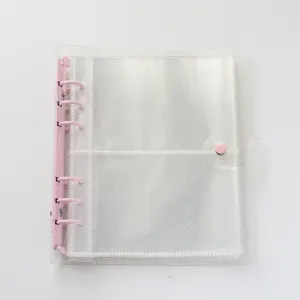 Transparent glitter 6-ring photocard binder detail with pink rings and snap button closure.