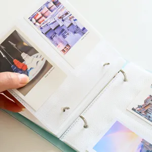 Closeup view of loose-leaf PP photo album featuring clear pockets and durable metal binder rings.