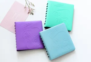 Detail view of pastel spiral photo albums for 3-inch mini instax pictures in vibrant colors.