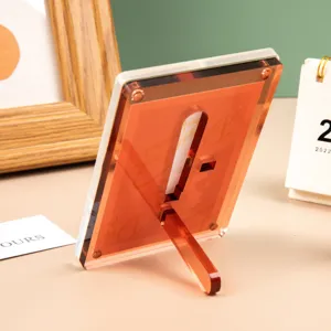 Marco de fotos acrilico transparente soporte para tarjetas con respaldo naranja.