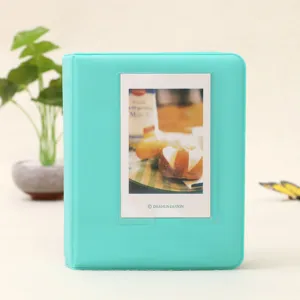 Mint green mini photo album pocket binder for Instax Polaroid cards. Cute pastel design.