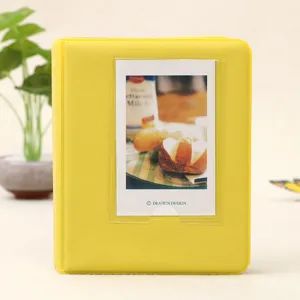 Yellow mini instax photo album with clear front pocket insert, portable card storage holder.