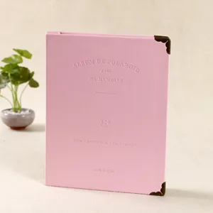 Detail view of a pink leather 3-inch Polaroid photo album with 120 pockets and metal corners.
