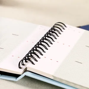 Close-up detail of a 3 inch polaroid photo album with black spiral binding and pocket inserts.