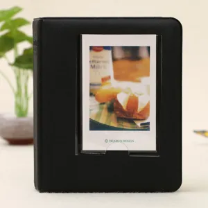 Black mini photo album for instax polaroid pictures with transparent pocket cover for display.