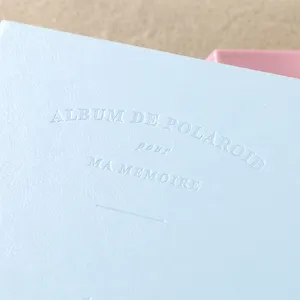 Light blue leather 3 inch polaroid photo album cover with debossed classic text design.