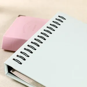 Close-up detail of light blue PU leather photo album with black rings and inner pages.