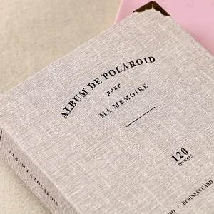 Detail view of a 3-inch fabric Polaroid photo album with elegant text print and 120 pockets.