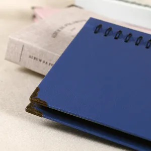 Blue leather 3-inch photo album detail featuring vintage metal corners and spiral binding.