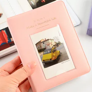 Pink mini 3-inch photo album for polaroid pictures with cute cover text and pocket design.