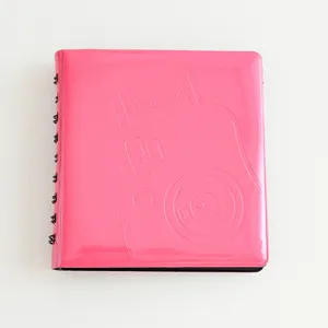 Close-up detail of the pink macaron ring photo album cover featuring instax embossed camera design.