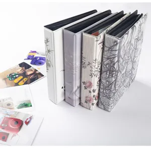 Detailed view of 3 inch instant photo albums with various floral and botanical cover designs.