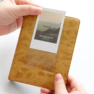 Retro 3-inch mini photo album detail showing transparent pocket and textured leather cover.