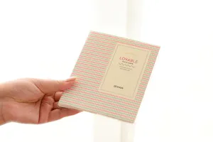 Mini polaroid photo album detail shot, cute diamond pattern cover with card slots.