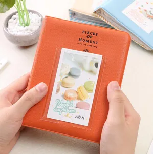Detailed view of orange 3-inch mini photo album with clear pocket and insert card display.