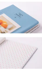 Detailed view of light blue mini photo album cover with star pattern inner pages for 3 inch photos.